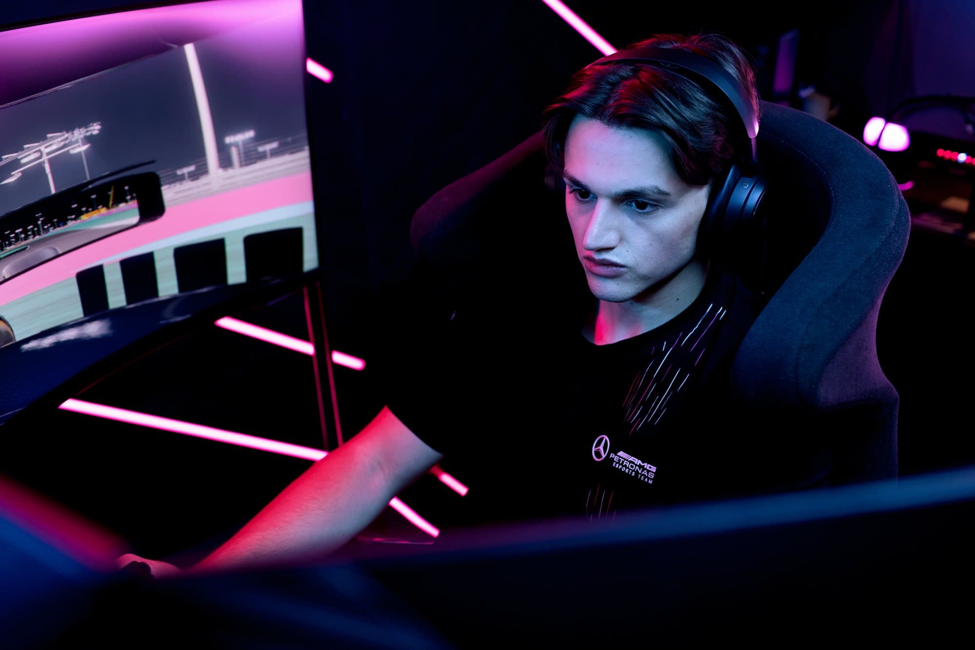 Marcel Kiefer with a headset in a simulator, pink light