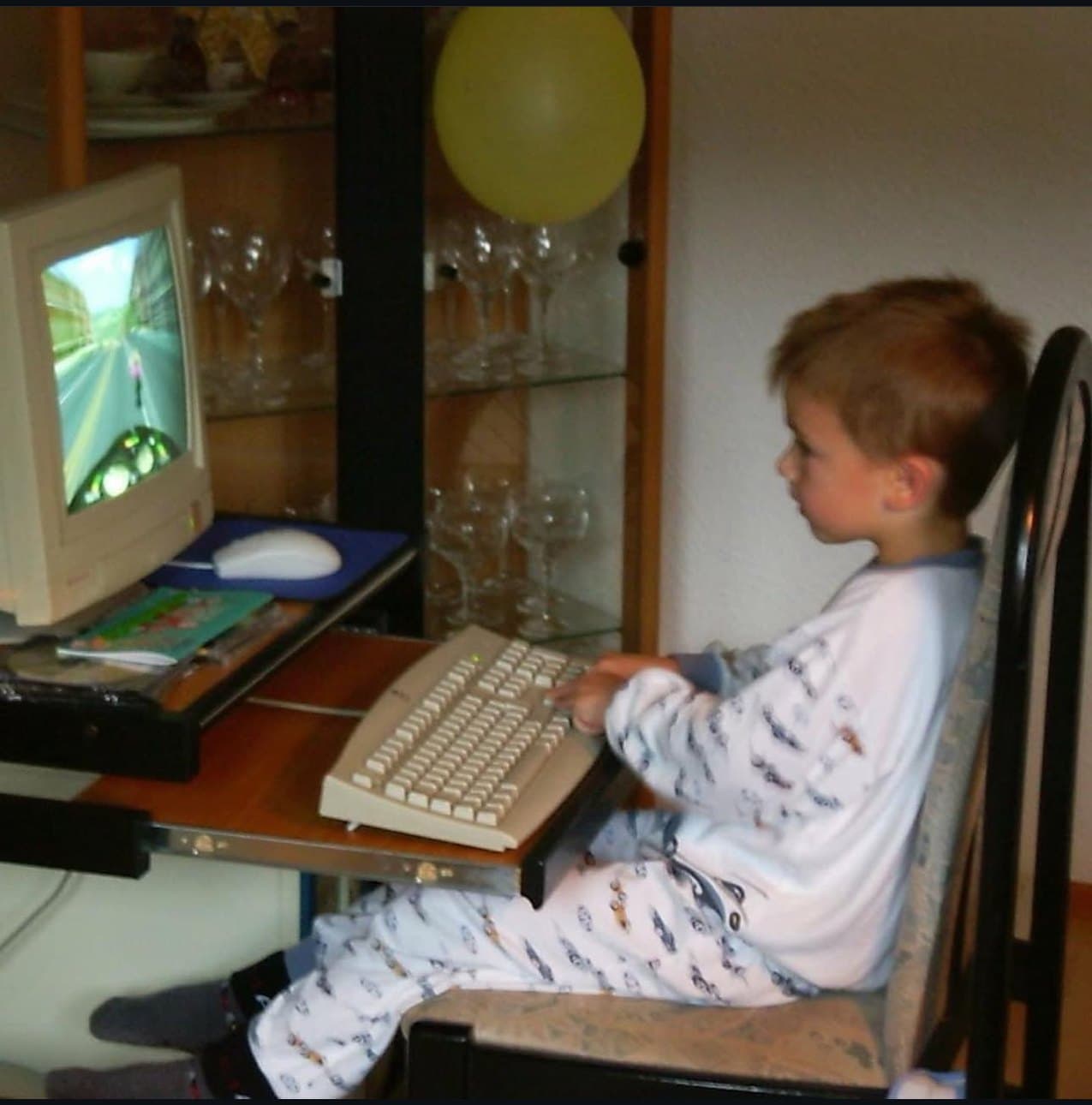 Marcel as a small child playing a racing game on a family PC