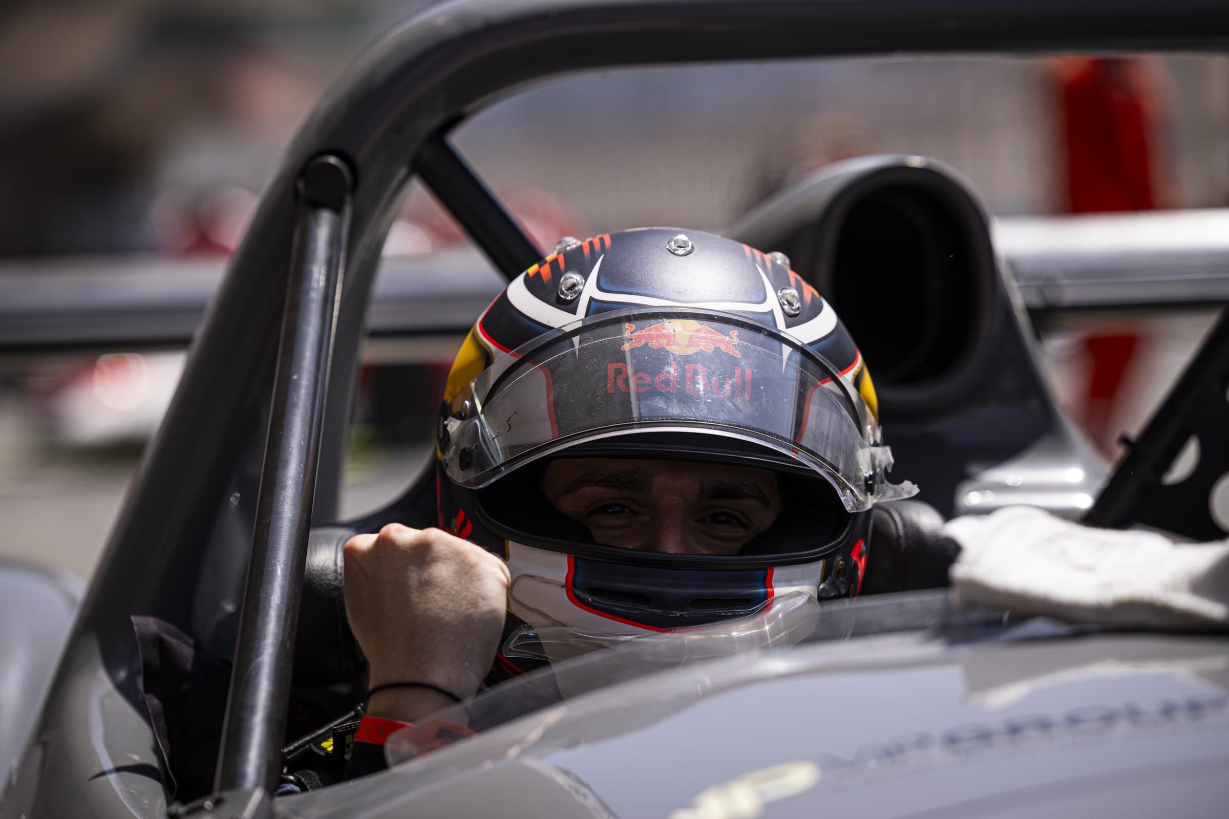 Marcel Kiefer in the cockpit of a Radical sports prototype, fist raised