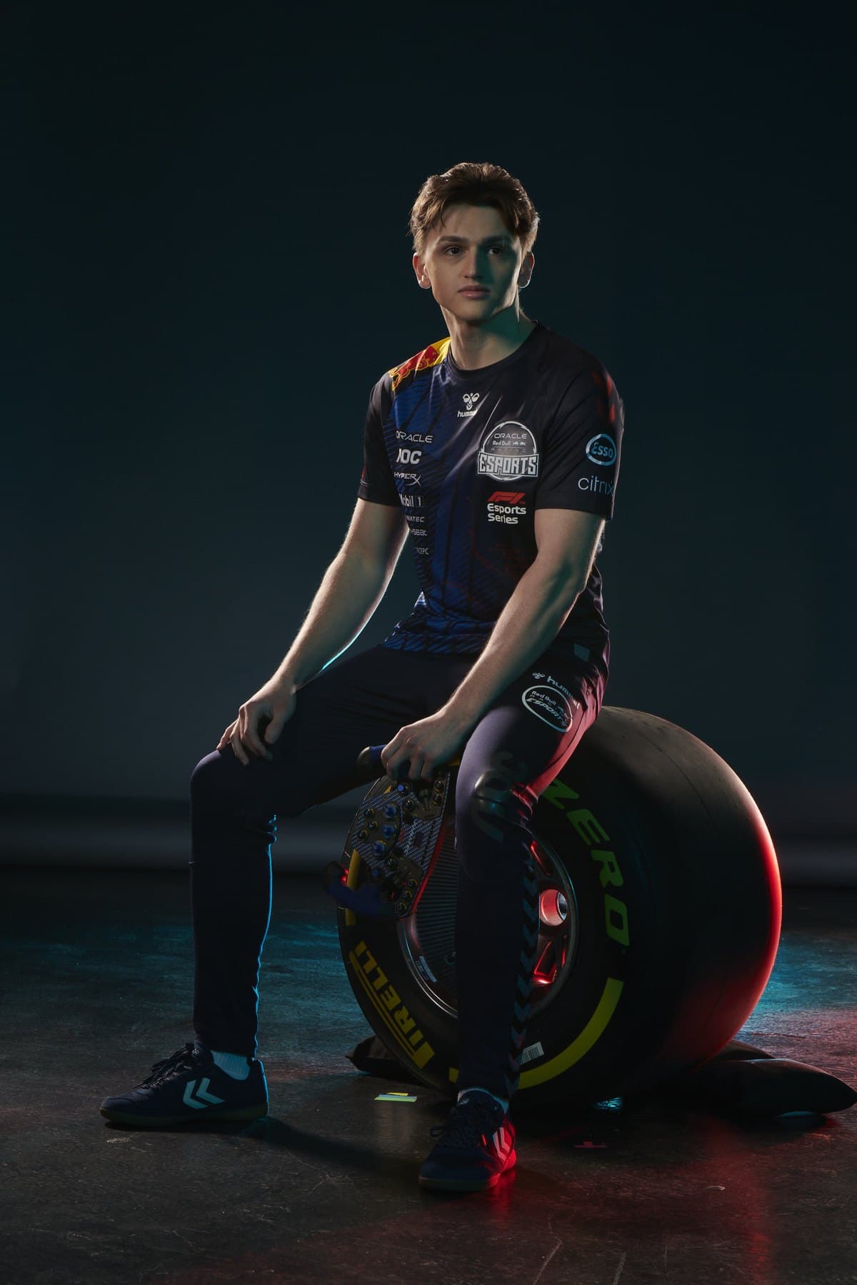 Marcel Kiefer seated on a Formula 1 tyre in a studio portrait
